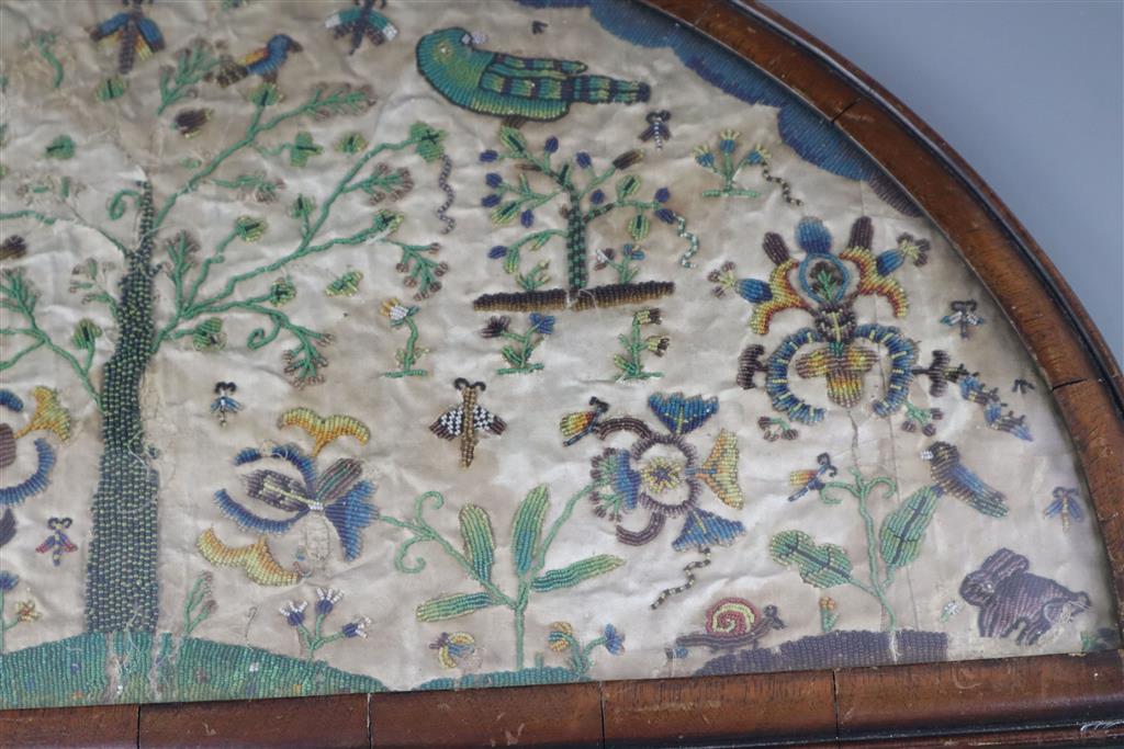 A late 17th century silk and bead work arched panel, width 22.5in. height 11.75in.